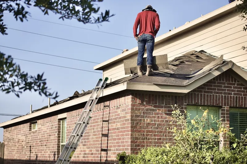 Professional roofer working on a residential roof in San Joaquin